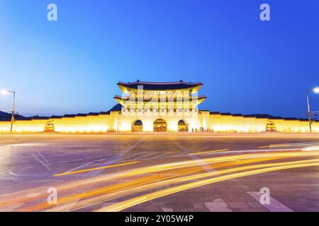 Long exposure car lights curving in front of Gwanghwamun main entrance gate to Gyeongbokgung Palace in historic part of downtown Seoul, South Korea on Stock Photo