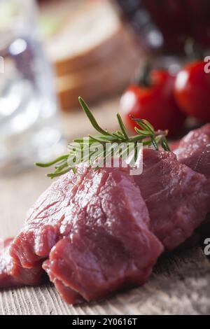 Cutlet, meat, raw, veal, steak, beef, rosemary, cooking, tomato, fresh, red, isolated, slice, background, sirloin, food, uncooked, dinner, preparation Stock Photo