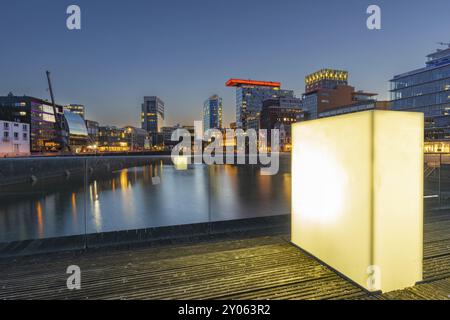 Illuminated pedestrian bridge over the harbour basin in the Media Harbour, Duesseldorf, North Rhine-Westphalia, Germany, Europe Stock Photo