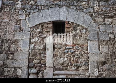 Medieval stone wall with inbuild arch and small window Stock Photo - Alamy