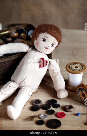 Simple old rag doll with attached red heart Stock Photo - Alamy