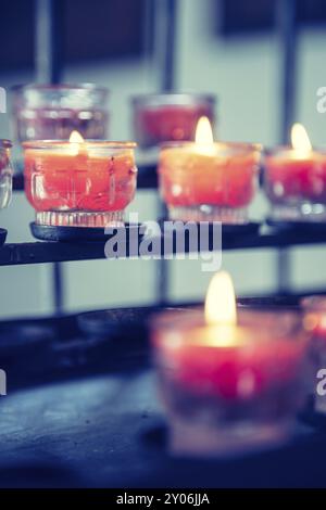 Close up of candles in old catholic church, blurry background Stock Photo