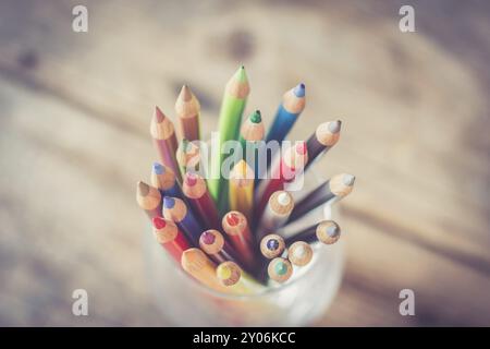 Colored pencils in a can on rustic wooden table Stock Photo