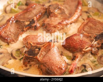 Tasty organic lamb chop with mushroom cream sauce, food concept Stock Photo