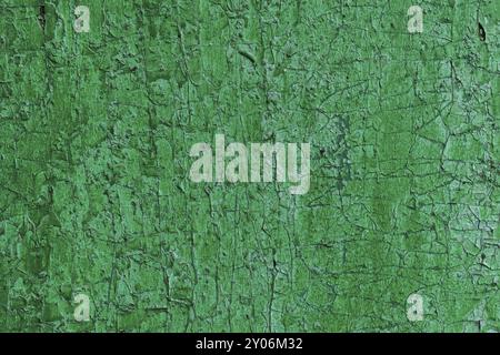 Texture of a wooden board in green, Cracked from time green paint on a wooden surface Stock Photo