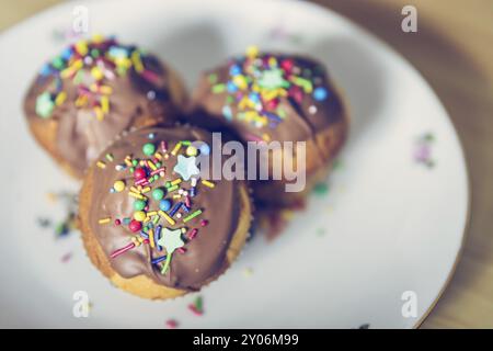 Homemade sweet cupcakes on a plate with colourful decoration Stock Photo