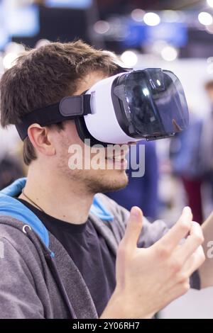 Young man is using virtual reality glasses on an expo Stock Photo