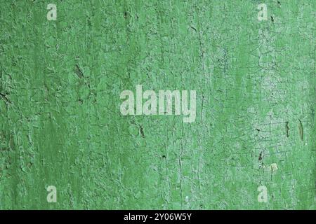 Texture of a wooden board in green, Cracked from time green paint on a wooden surface Stock Photo