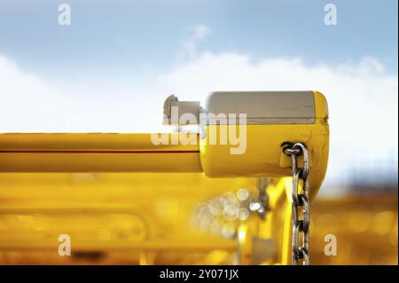 Open lock of a yellow shopping trolley Stock Photo