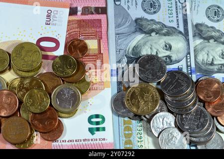 Background of European and American money banknotes and coins, 100 American dollars, 10 Euros European cash with dollar, euro coin, different values o Stock Photo