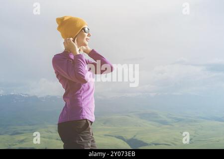 A hipster girl in a straw hat and glasses on the nature landscape Stock Photo