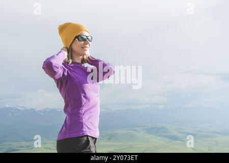 A hipster girl in a straw hat and glasses on the nature landscape Stock Photo