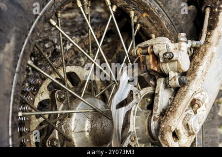 A close-up of the disc rear brakes of an off-road enduro motorcycle. The concept of motorsport Stock Photo