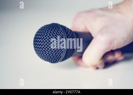 Close up picture of a black in the hand of a journalist microphone Stock Photo