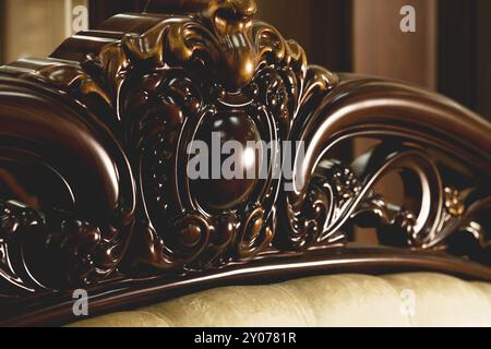 Close-up Brown wooden carved patterns headboard of a double bed. Retro Stylish Bedroom Stock Photo