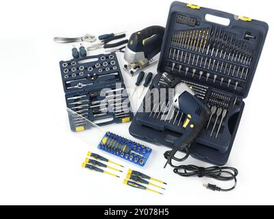 Electric drill, a jigsaw, thread cutting dies and taps, drill bits and other tools isolated on white background Stock Photo