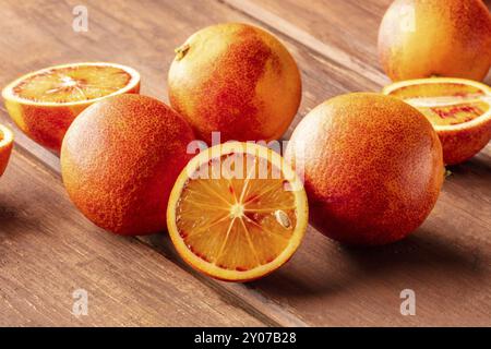 A photo of organic blood oranges on a dark rustic background with a place for text Stock Photo