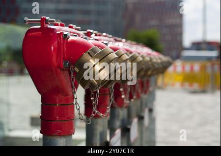 Red extinguishing water connections in front of an office building Stock Photo