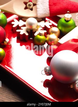 Colorful Christmas decoration on a rustic red ceramic plate Stock Photo