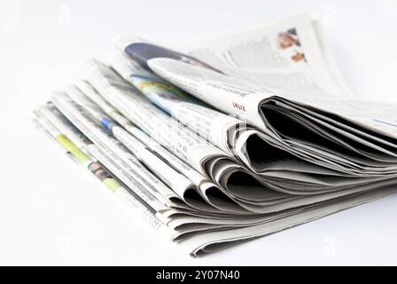 Stack of newspapers in front of a white background Stock Photo