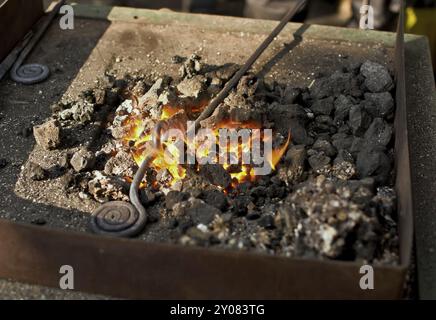 Horizontal, landscape, detail, hot, close-up, work, glow, background, embers, glowing, handwork, medieval, history, movement, craft, craftsmanship, be Stock Photo