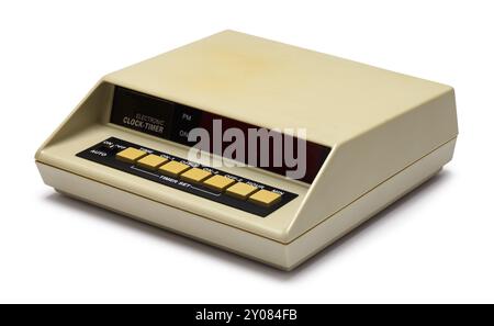 Old Electronic Clock Timer Cut Out on White. Stock Photo