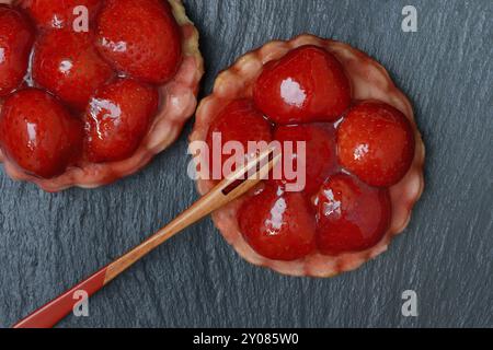 Topped strawberry tarts with a fork Stock Photo