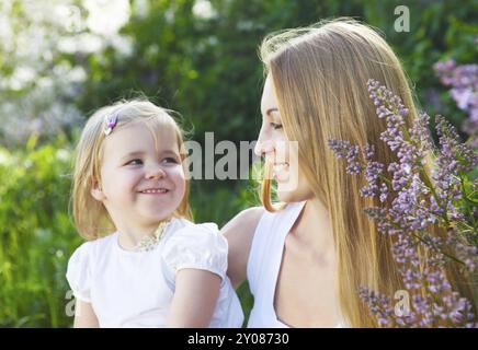 Happy mother and her little daughter in the spring day Stock Photo