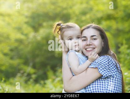 Happy mother and her little daughter in the spring day Stock Photo