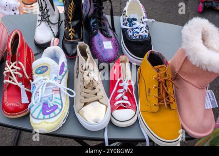 Selection of secondhand shoes and boots for sale at the car boot sale, Ayr, Ayrshire, Scotland, UK Stock Photo