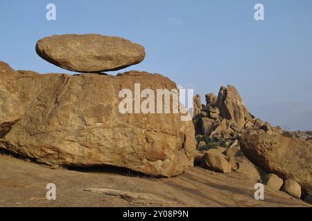 Big balancing granite boulder and mountain in Hampi, India. Travel destination in India. Unique landscape. Popular region for bouldering Stock Photo