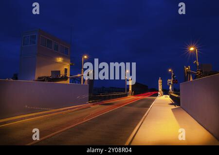 Road, which leads over a modern lift bridge, at night Stock Photo