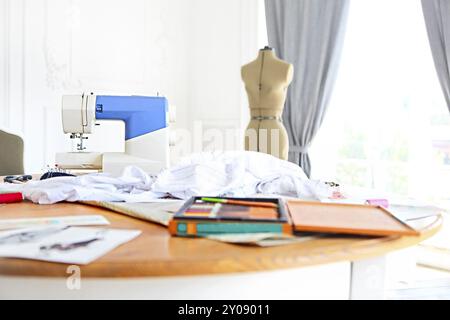 Sewing machine, dummy and other sewing equipment in the desighners workplace Stock Photo