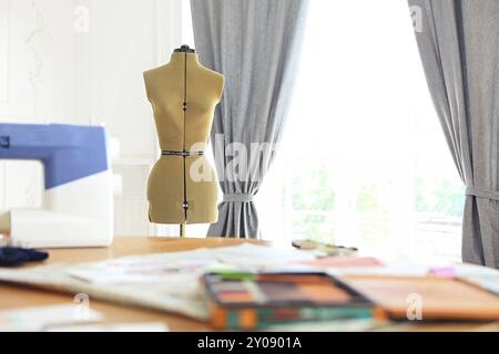 Sewing machine, dummy and other sewing equipment in the desighners workplace Stock Photo
