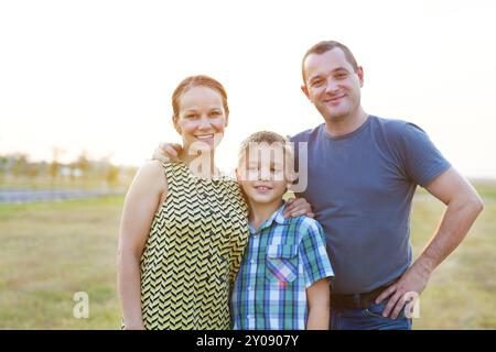 Happy young family with little son outdoors. Outdoors portrait Stock Photo