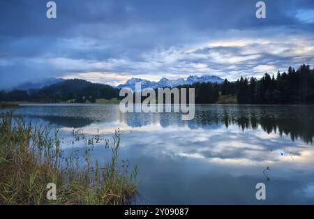 Rainy sunrise over Geroldsee lake with view on Karwendel mountain range, Bavaria Stock Photo