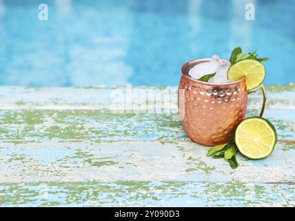Natural lime and lemon homemade lemonade in cooper mug on rustic wooden background Stock Photo