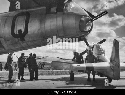 North American P-51 Mustang Under The Tail Of A Boeing B-17 Flying Fortress. Brest, France, circa 1945 Stock Photo