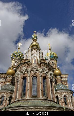 Church with ornate domes, golden crosses and colourful mosaics against a blue, partly cloudy sky, st. petersburg, russia Stock Photo