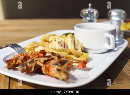 Seafood on the plate in the outdoors summer restarant Stock Photo