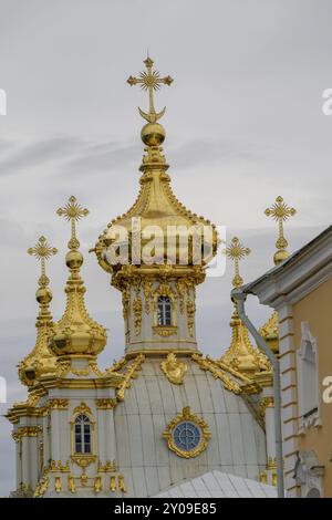 Church domes with golden decorations and crosses on a cloudy sky on an architectural building, saint petersburg, baltic sea, russia Stock Photo