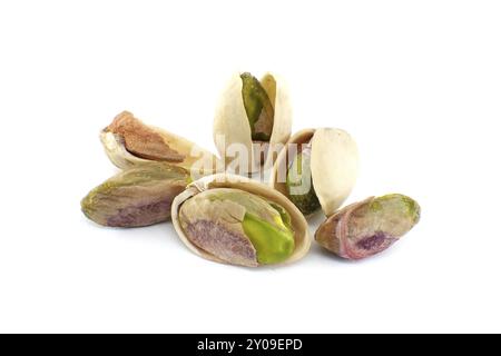 Pistachios in-shell and others peeled exposing the green nuts inside isolated on white background Stock Photo