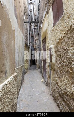 Narrow alley in the city of Fes in Morocco Stock Photo