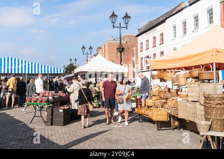 People walking through Ludlow open air market, Shropshire, England, UK Stock Photo