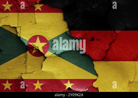 Flags of Grenada and Germany painted on cracked wall Stock Photo