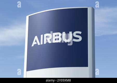 Close-up, sign with the logo against a blue sky at the entrance to the Airbus plant in Finkenwerder, Hamburg, Germany, Europe Stock Photo