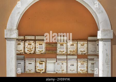 Weathered letterboxes mounted on the wall Stock Photo