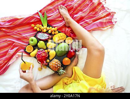 Young woman and exotic fruits on the tray Close up Stock Photo