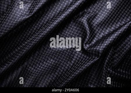 black vegan leather with pattern, fake crumpled textile texture Stock Photo