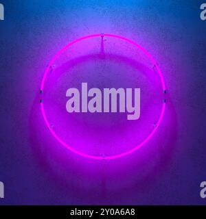 Neon sign. Round frame with purple glowing. Electric bright 3d circle on dark blue backdrop. Neon abstract background. 3d illustration. Stock Photo